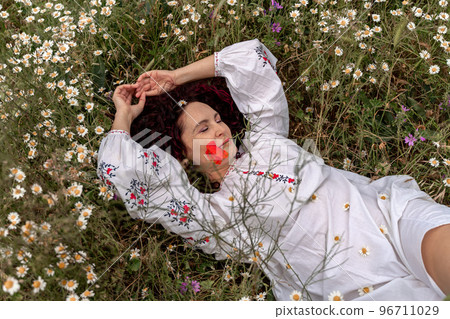 A beautiful woman lies on her back in a field and lifts up her beautiful legs. Good morning A beautiful woman lies on her back in a field and lifts up her beautiful legs. Good morning 96711029
