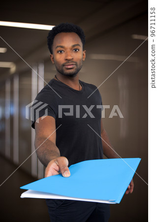 office worker giving folder document to colleague holding paperwork working on file office worker giving folder document to colleague holding paperwork working on file 96711158