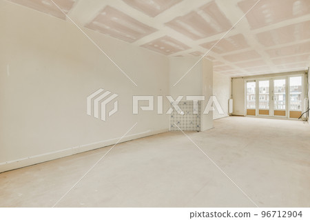 Empty room with windows and radiator in daylight Empty room with windows and radiator in daylight 96712904