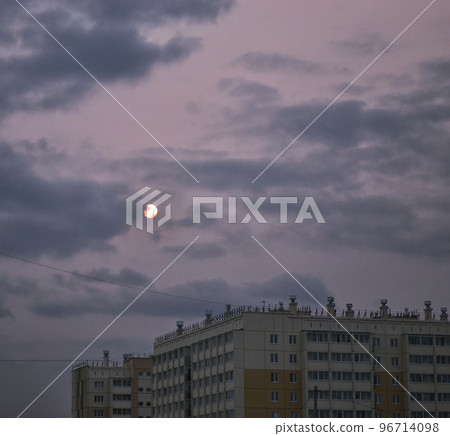 Sun behind clouds in a gloomy sky, house and smog 96714098