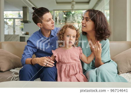 Married lesbian couple spending weekend at home with little daughter 96714641