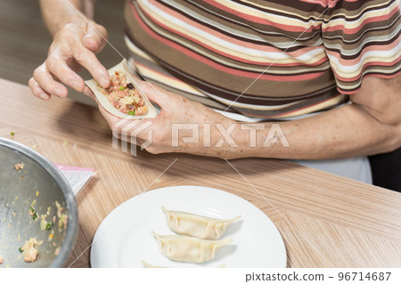 Senior wrapping dumplings Senior wrapping dumplings 96714687