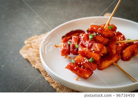 deep fried Korean rice cake (Tteokbokki) skewered with spicy sauce 96716450