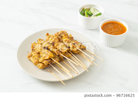 Pork satay with peanut sauce pickles which are cucumber slices and onions in vinegar Pork satay with peanut sauce pickles which are cucumber slices and onions in vinegar 96716625