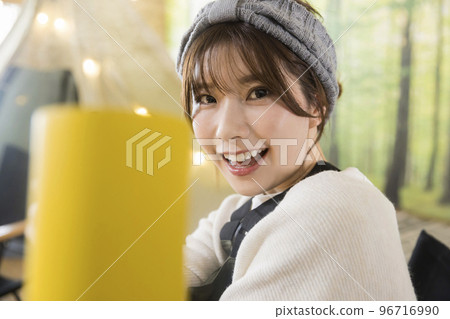 A young woman toasting with a mug at Iekya Glamping Cafe 96716990