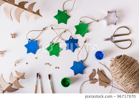Diy handmade Christmas decorations gouache-painted cardboard stars. Top view. Diy handmade Christmas decorations gouache-painted cardboard stars. Top view. 96717870