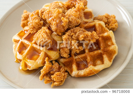 fried chicken waffle with honey or maple syrup 96718008