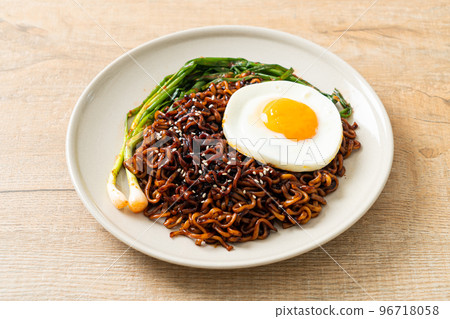 dried Korean spicy black sauce instant noodles with fried egg and kimchi dried Korean spicy black sauce instant noodles with fried egg and kimchi 96718058