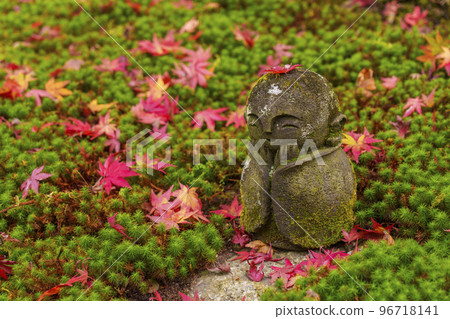 Enkoji temple in Kyoto Jizo statue with a maple leaf on its head 96718141