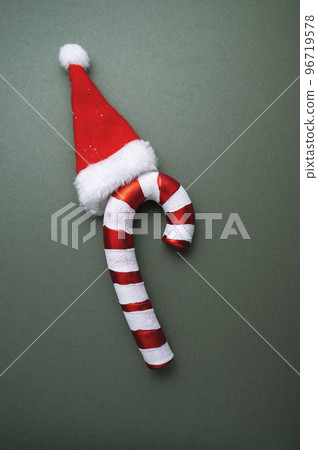 Christmas green background. Seasonal ornament candy canes. Creative flat lay, top view copy space 96719578