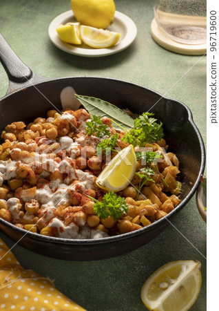 Cooked Chickpea in frying pan with curry and spices, homemade vegan chickpeas, healthy food, colorful green background Cooked Chickpea in frying pan with curry and spices, homemade vegan chickpeas, healthy food, colorful green background 96719600
