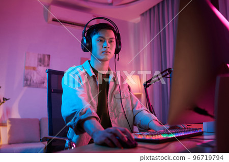 Serious young man taking part in videogame tournament Serious young man taking part in videogame tournament 96719794