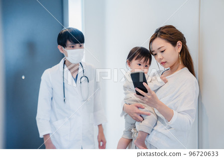 Parents and children calling a doctor with a home medical app 96720633