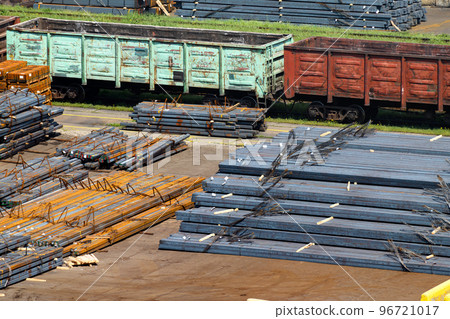 industrial infrastructure of the seaport, a warehouse by the sea with railway wagons, iron billets, metal structures, the concept of marine cargo transportation 96721017