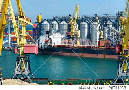 industrial seaport infrastructure, sea, cranes and dry cargo ship, grain silo, bulk carrier vessel and grain storage elevators, concept of sea cargo transportation 96721035