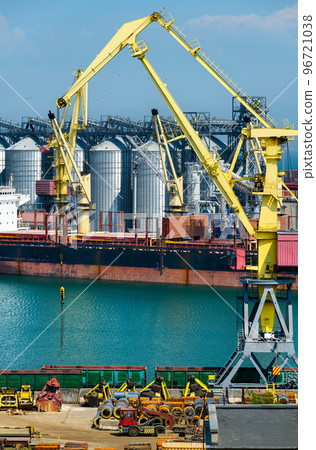 industrial seaport infrastructure, sea, cranes and dry cargo ship, grain silo, bulk carrier vessel and grain storage elevators, concept of sea cargo transportation 96721038