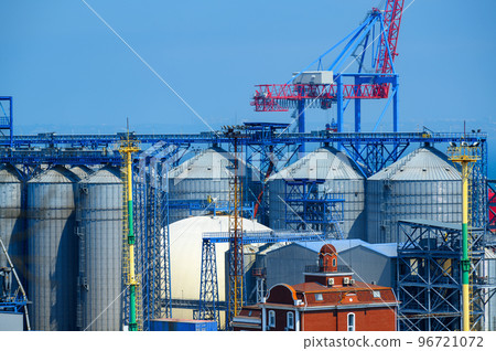 industrial seaport infrastructure, sea, cranes and dry cargo ship, grain silo, bulk carrier vessel and grain storage elevators, concept of sea cargo transportation industrial seaport infrastructure, sea, cranes and dry cargo ship, grain silo, bulk carrier vessel and grain storage elevators, concept of sea cargo transportation 96721072