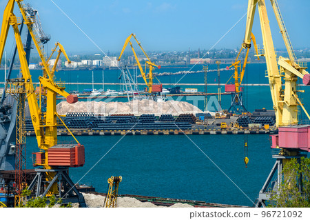 industrial seaport infrastructure - sea, cranes and minerals, metal and bundles of wire, concept of maritime cargo transportation 96721092