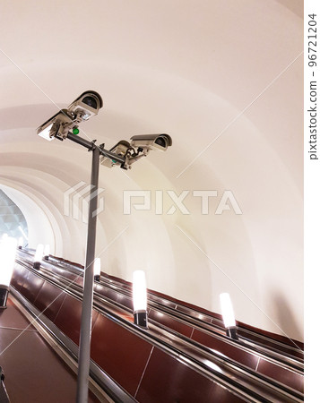 Four cameras underground on the subway station on escalator. Security concept Four cameras underground on the subway station on escalator. Security concept 96721204