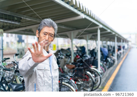 Senior man of administrator to stop at bicycle parking lot 96721360