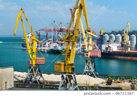 Odessa, Ukraine, May 4, 2019 - industrial seaport infrastructure, sea, cranes and dry cargo ship, grain silo, bulk carrier vessel and grain storage elevators, concept of sea cargo transportation Odessa, Ukraine, May 4, 2019 - industrial seaport infrastructure, sea, cranes and dry cargo ship, grain silo, bulk carrier vessel and grain storage elevators, concept of sea cargo transportation 96721367