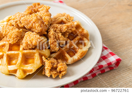 fried chicken waffle with honey or maple syrup 96722761