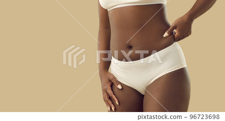 Ethnic woman insecure with body shape and curves Ethnic woman insecure with body shape and curves 96723698