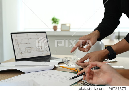 Engineer or architect team brainstorming, planning development details at construction office 96723875