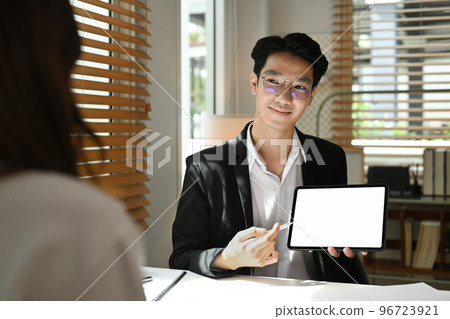 Two young business investor discussing financial paperwork, talking about company business growth at office Two young business investor discussing financial paperwork, talking about company business growth at office 96723921