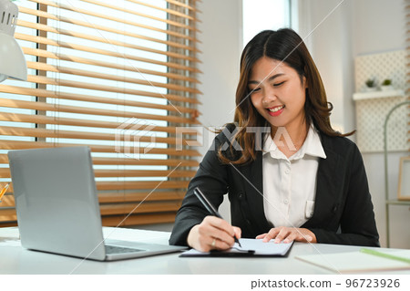 Beautiful asian female investor working online, analyzing financial online data on laptop computer 96723926