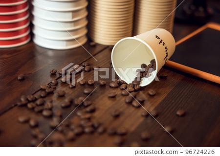 Cafe interior with roasted coffee beans on a wooden table Cafe interior with roasted coffee beans on a wooden table 96724226