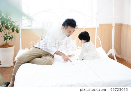 Cute family relaxing in the bedroom Cute family relaxing in the bedroom 96725033