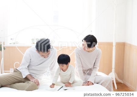 Family relaxing in the bedroom with copy space Family relaxing in the bedroom with copy space 96725034