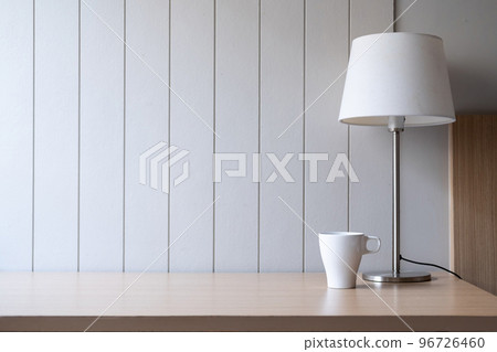 Workplace with space - Lamp on old wood table with space of rough cement wall in white color tone Workplace with space - Lamp on old wood table with space of rough cement wall in white color tone 96726460