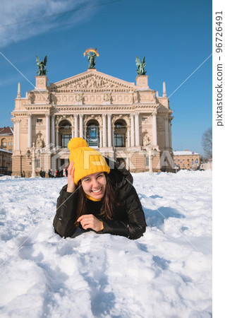 happy woman traveler in front of opera building in lviv city happy woman traveler in front of opera building in lviv city 96726491