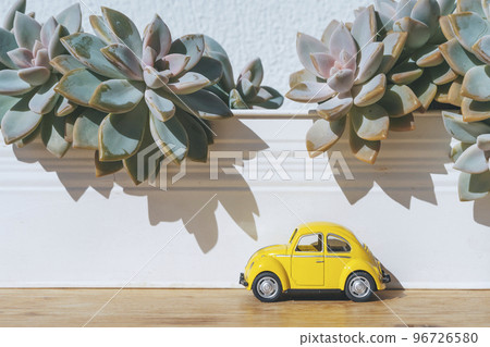 Travel car concept. Toy yellow car moves on against the backdrop of nature. Driving, adventure, discovery idea Travel car concept. Toy yellow car moves on against the backdrop of nature. Driving, adventure, discovery idea 96726580
