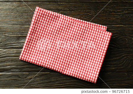 Red and white checkered tablecloth on wooden background 96726715