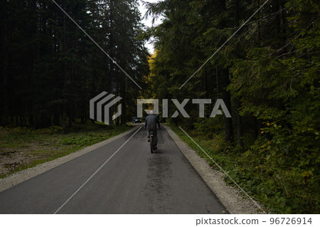 Mountain biking man riding on bike at sunset mountains forest landscape. Family sport and fitness outdoors Mountain biking man riding on bike at sunset mountains forest landscape. Family sport and fitness outdoors 96726914