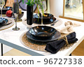 Table setting with black dishes for a festive romantic dinner or homemade dinner 96727338