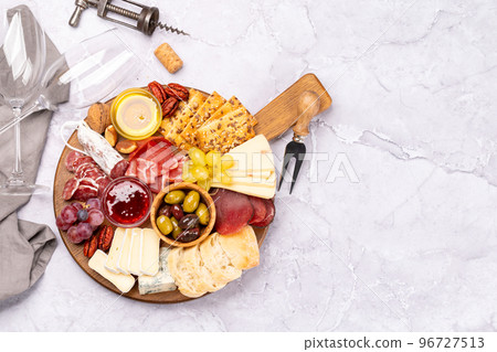 Antipasto board with prosciutto, salami, crackers, cheese Antipasto board with prosciutto, salami, crackers, cheese 96727513