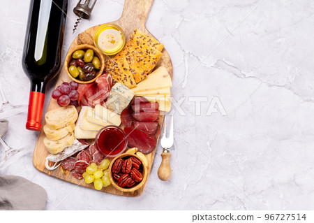 Antipasto board with prosciutto, salami, crackers, cheese Antipasto board with prosciutto, salami, crackers, cheese 96727514