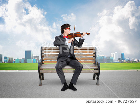 Young businessman plays the violin 96727657