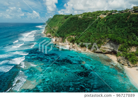 Beautiful coastline with blue ocean and green cliffs in Bali. Aerial view Beautiful coastline with blue ocean and green cliffs in Bali. Aerial view 96727889