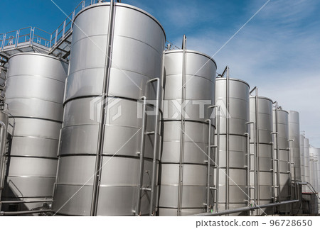 Steel tanks for wine fermentation at a modern winery. Large brewery silos for barley or beer 96728650