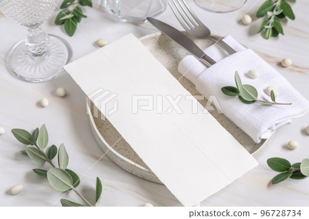 Elegant Table setting with a card decorated with eucalyptus branches close up, Wedding mockup Elegant Table setting with a card decorated with eucalyptus branches close up, Wedding mockup 96728734
