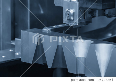 The wire EDM machine cutting the mold insert parts. The wire EDM machine cutting the mold insert parts. 96728861