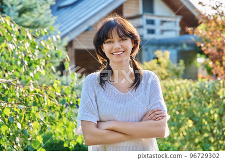Outdoor portrait of positive teenage female looking at camera 96729302