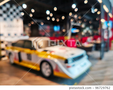 Blurred and Soft focus of retro sport car model on display in a car dealership. Blurred and Soft focus of retro sport car model on display in a car dealership. 96729762