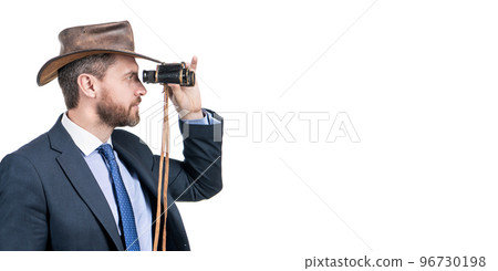 Professional man in cowboy hat look through binoculars isolated on white copy space, business vision Professional man in cowboy hat look through binoculars isolated on white copy space, business vision 96730198