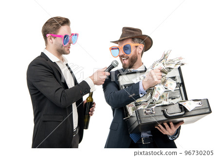 Newsman interview happy winner. Winning man hold money suitcase. Big money 96730205